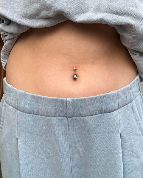 belly button piercing with blue gems